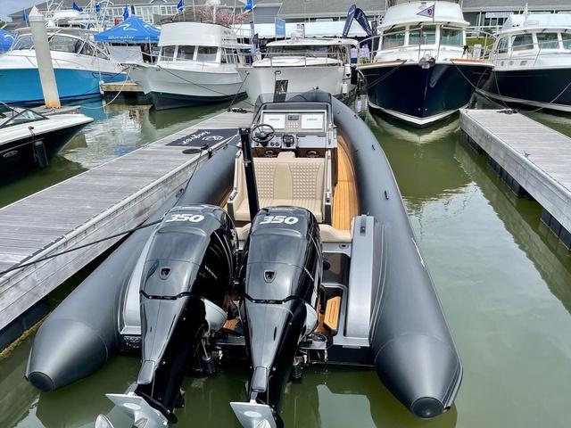 Slide: The Image of 2022 Roughneck RIB 1010 boat with dual 350 engines docked at marina. - 2