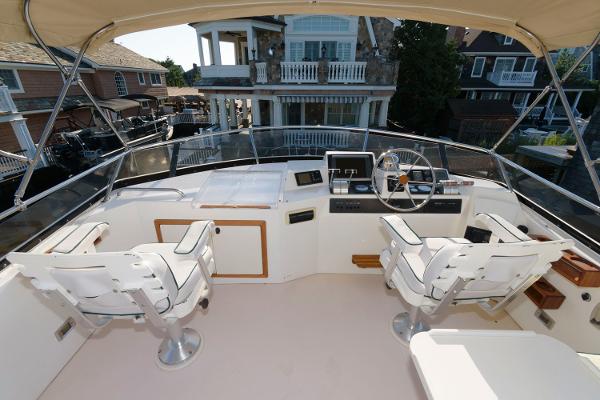 Slide: The Image of Flybridge of 2000 Sabreline 47 Motor Yacht with dual captain chairs and control panel. - 7