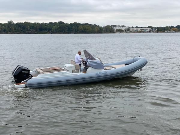 Slide: The Image of 2024 SACS Strider 900 boat cruising on a lake. - 1