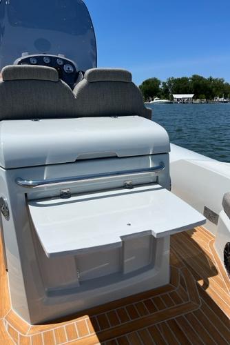 Slide: The Image of 2024 SACS Strider 900 boat interior with fold-out table on deck. - 8