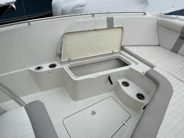 Slide: The Image of 2006 Sailfish 2360 CC boat interior with open storage compartment and seating. - 19