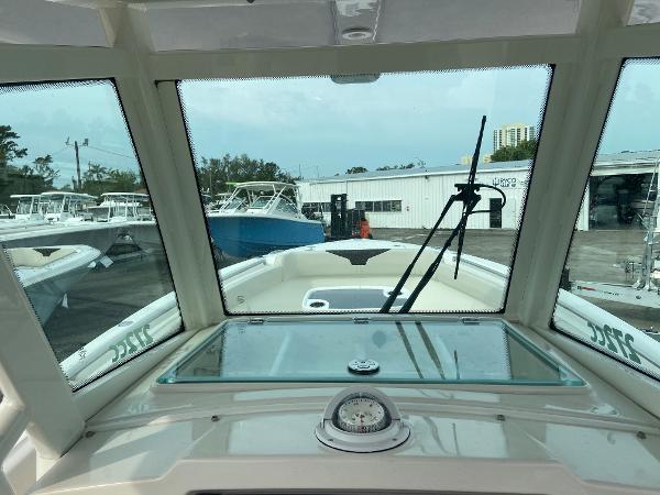 Slide: The Image of View from the helm of a 2023 Sailfish 272 CC boat in a marina. - 14