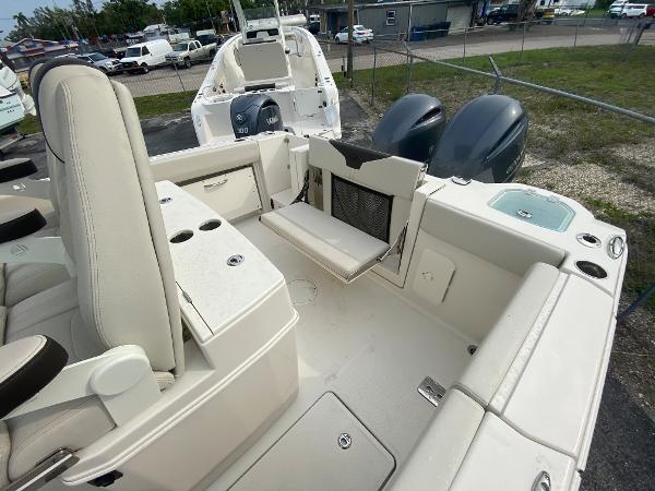 Slide: The Image of 2023 Sailfish 272 CC boat interior with seating and dual outboard motors. - 16