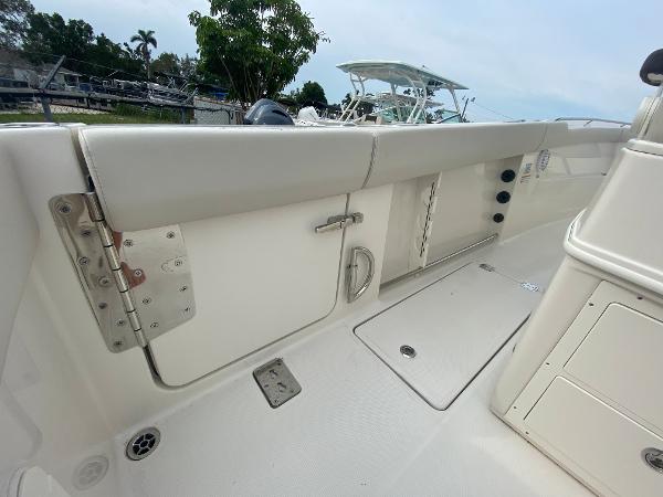 Slide: The Image of 2023 Sailfish 272 CC boat interior, featuring storage compartments and seating. - 18