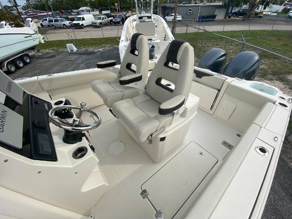 Slide: The Image of 2023 Sailfish 272 CC boat interior with dual captain's chairs and modern helm. - 25