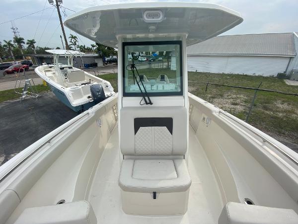 Slide: The Image of 2023 Sailfish 272 CC center console boat with cushioned seating and windshield. - 27