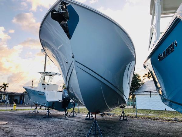 Slide: The Image of 2023 Sailfish 272 CC boat on stands at a marina. - 3