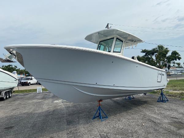 Slide: The Image of 2023 Sailfish 272 CC boat on stands in a parking lot. - 8