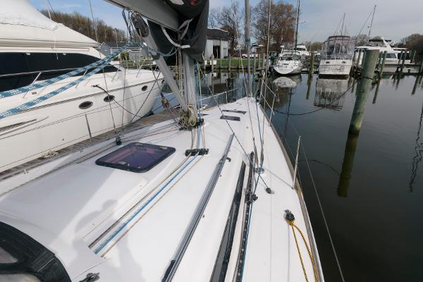 Slide: The Image of 2013 Salona 38 sailboat docked at a marina, showing deck and rigging. - 11