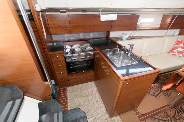 Slide: The Image of 2013 Salona 38 yacht kitchen with stove, sink, and wooden cabinetry. - 20