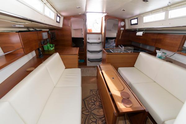 Slide: The Image of Interior of 2013 Salona 38 sailboat with white seating and wooden finishes. - 22