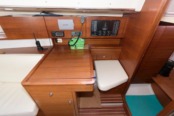 Slide: The Image of Navigation station of 2013 Salona 38 sailboat with wooden cabinetry and control panel. - 23