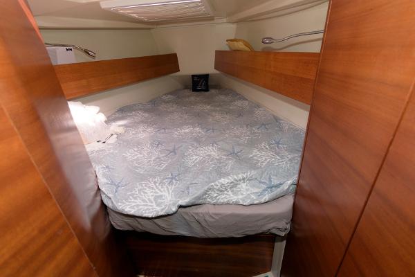 Slide: The Image of 2013 Salona 38 yacht interior cabin with cozy bed and wooden finish. - 26
