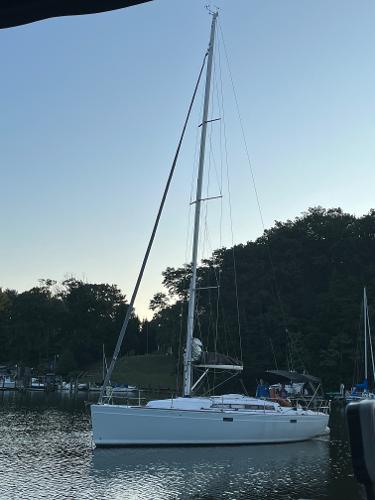 Slide: The Image of 2013 Salona 38 sailboat docked in a serene marina at sunset. - 3