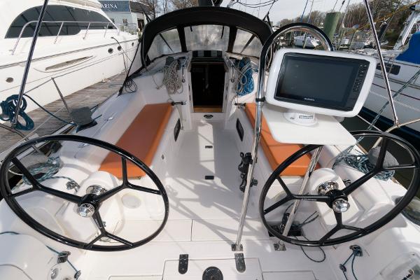 Slide: The Image of 2013 Salona 38 sailboat cockpit with dual steering wheels and navigation system. - 7