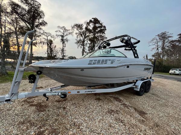 Slide: The Image of 2023 Sanger 231 SL boat on a trailer in a wooded area. - 10