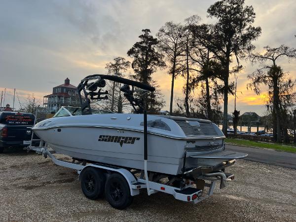 Slide: The Image of 2023 Sanger 231 SL boat on trailer at sunset by lakeside. - 11