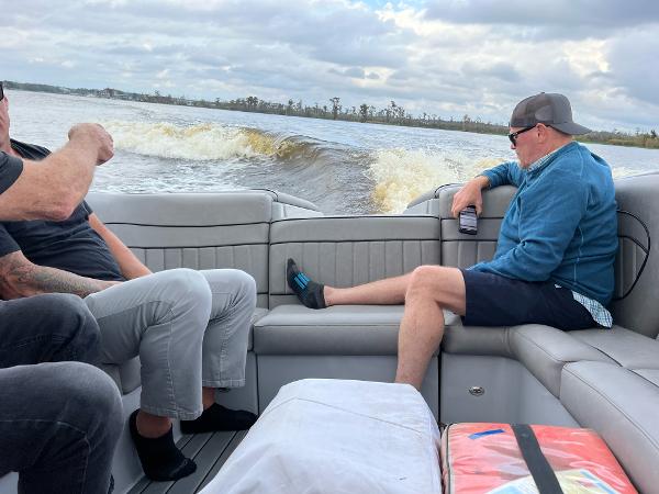 Slide: The Image of People relaxing on a 2023 Sanger 231 SL boat on a lake. - 21