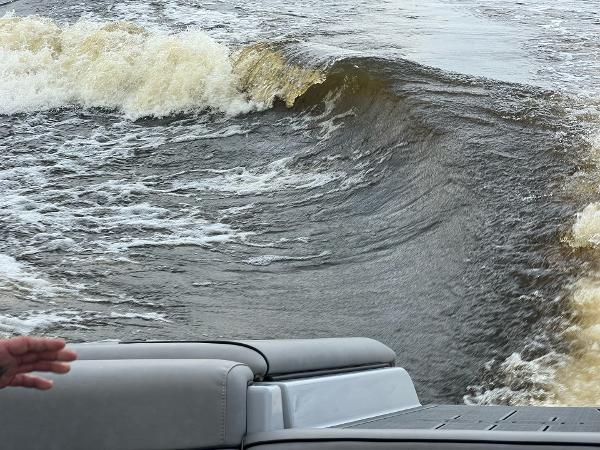 Slide: The Image of 2023 Sanger 231 SL boat creating a large wake on the water. - 23