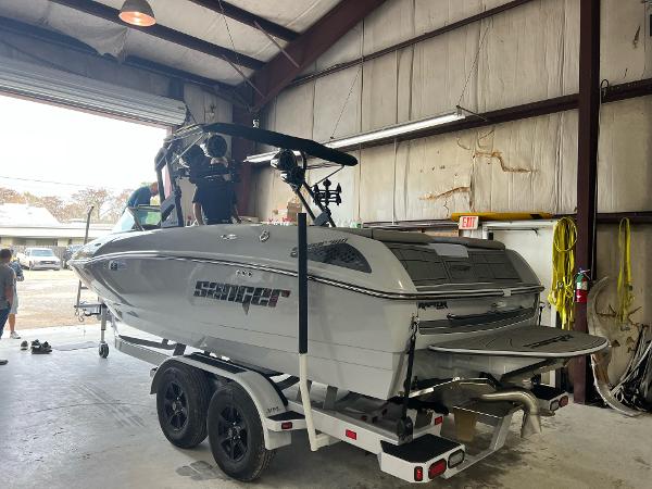 Slide: The Image of Sanger 231 SL 2023 model boat on a trailer inside a warehouse. - 31