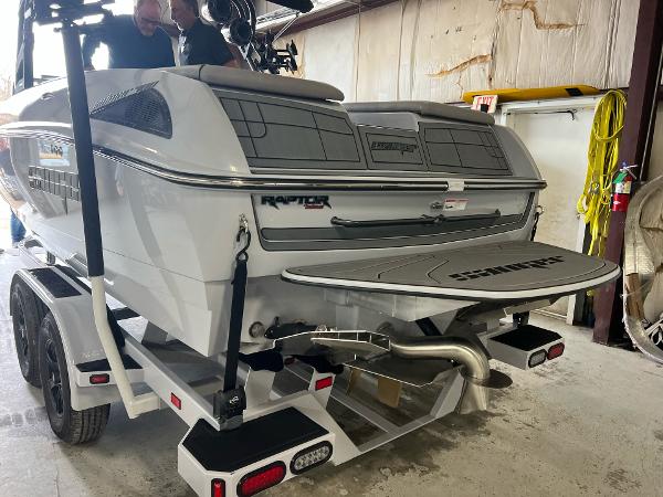 Slide: The Image of 2023 Sanger 231 SL boat on trailer in a garage. - 32