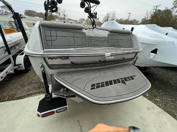 Slide: The Image of 2023 Sanger 231 SL boat rear view with swim platform and Raptor engine. - 33