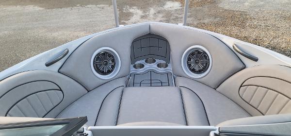 Slide: The Image of 2023 Sanger 231 SL boat interior with cushioned seating and built-in speakers. - 35