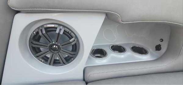 Slide: The Image of 2023 Sanger 231 SL boat interior speaker and cup holders. - 41