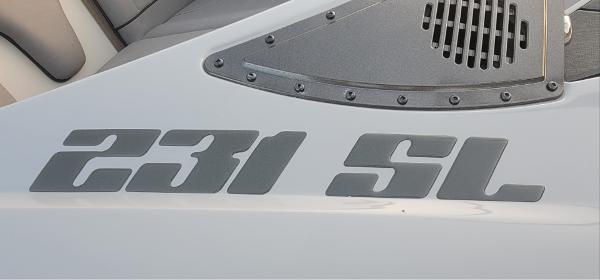 Slide: The Image of 2023 Sanger 231 SL boat model logo on white surface. - 45