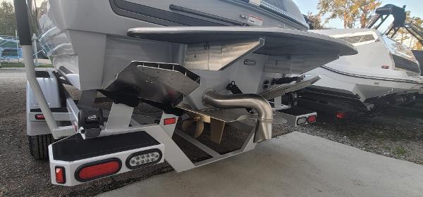 Slide: The Image of Rear view of 2023 Sanger 231 SL boat on trailer, showcasing exhaust and propeller. - 46