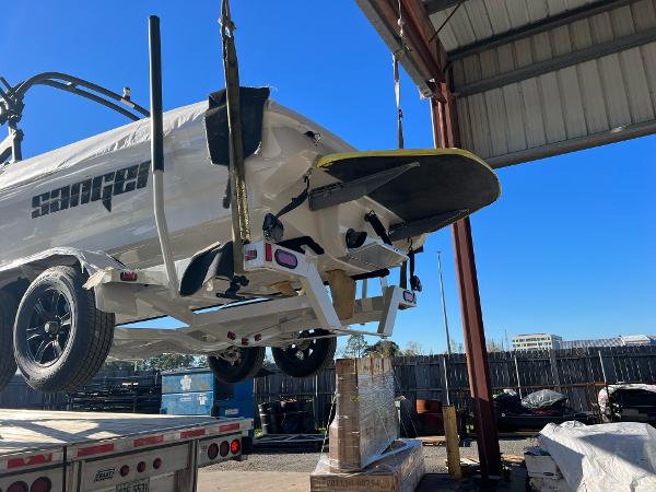 Slide: The Image of 2023 Sanger 231 SL boat on trailer in a storage facility. - 48
