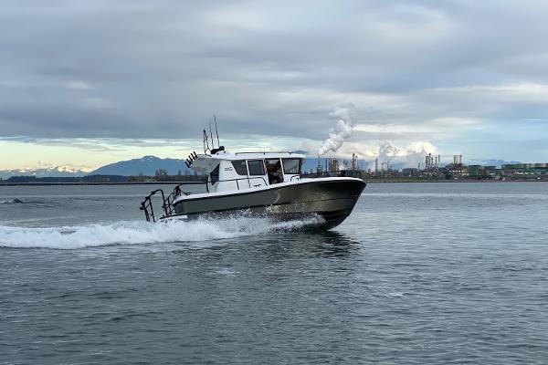 Slide: The Image of Sargo 25 boat cruising on water, 2021 model, industrial background. - 0