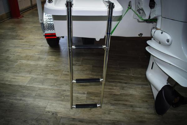 Slide: The Image of 2023 Savannah SS19 boat with extended ladder on wooden floor. - 14