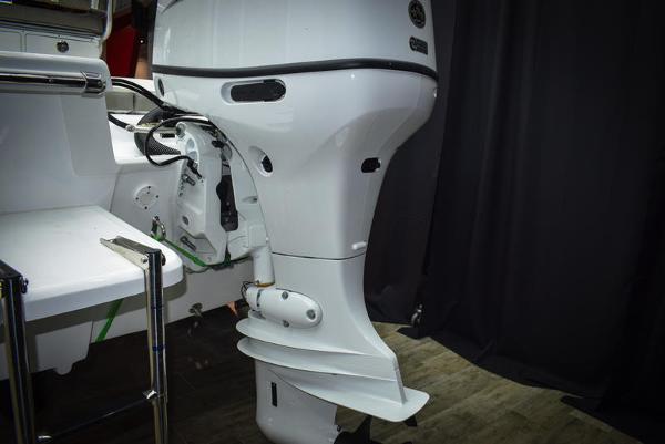 Slide: The Image of 2023 Savannah SS19 boat with outboard motor in a showroom. - 15