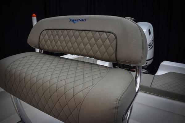 Slide: The Image of Savannah SS19 2023 boat seat with diamond-stitched upholstery and Suzuki outboard motor. - 16