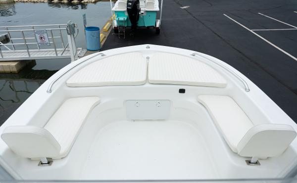 Slide: The Image of 2023 Savannah SS21 boat bow seating area with white cushions at dock. - 11
