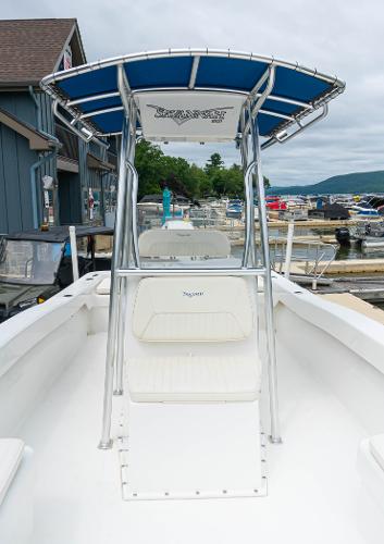 Slide: The Image of 2023 Savannah SS21 boat docked at a marina with blue T-top. - 13