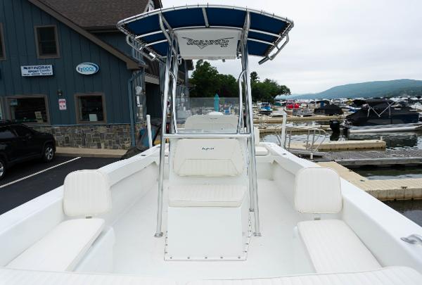 Slide: The Image of 2023 Savannah SS21 boat docked at marina, featuring spacious seating and blue canopy. - 14