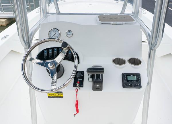 Slide: The Image of 2023 Savannah SS21 boat console with steering wheel, gauges, controls, and cup holders. - 5