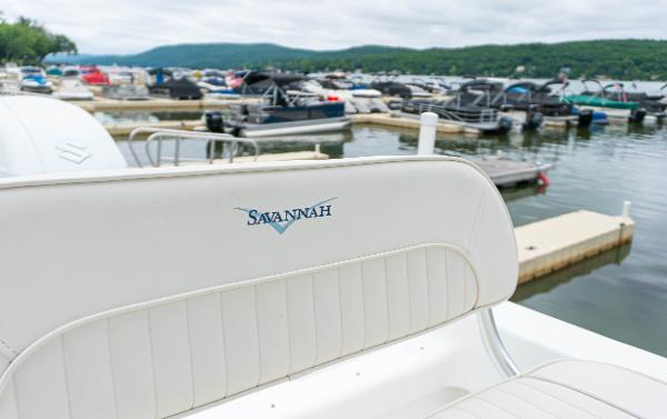 Slide: The Image of Savannah SS21 boat at a marina, 2023 model, with docked boats in the background. - 8