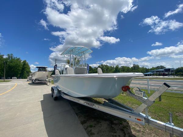 Slide: The Image of 2024 Savannah SS21 boat on trailer under blue sky. - 2