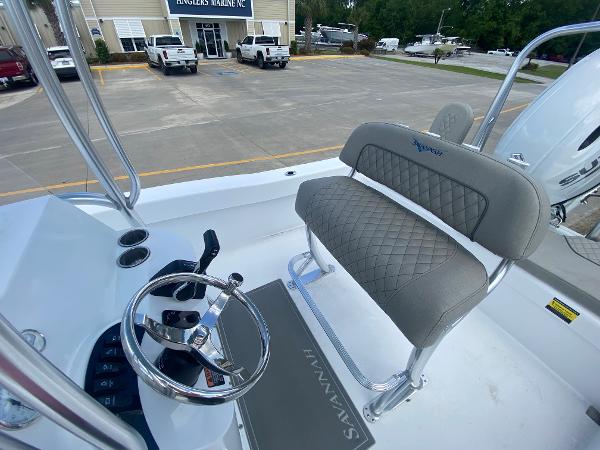 Slide: The Image of 2024 Savannah SS21 boat interior with steering wheel and cushioned seating. - 7