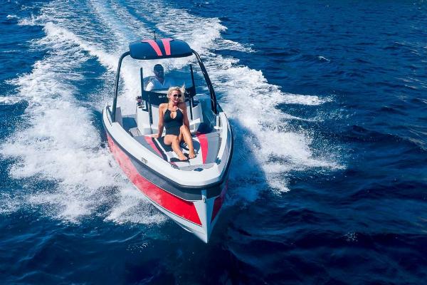 Slide: The Image of 2023 Saxdor 200 Pro Sport boat cruising on open water. - 0
