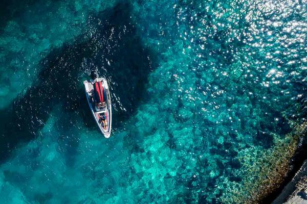 Slide: The Image of Aerial view of 2023 Saxdor 200 Pro Sport boat on clear turquoise water. - 1