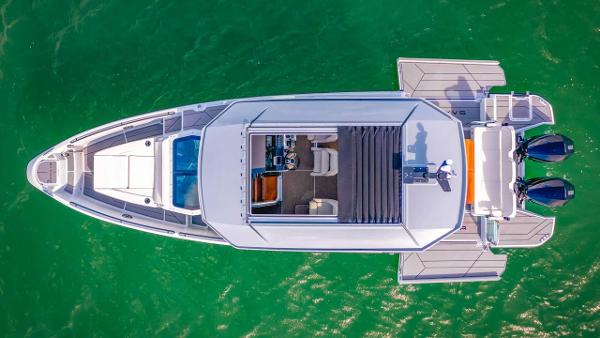 Slide: The Image of Aerial view of 2024 Saxdor 320 GTC boat on green water. - 10