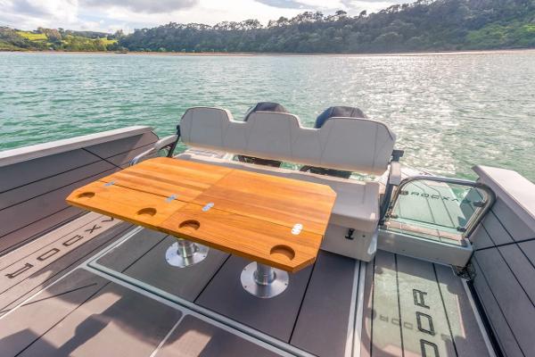 Slide: The Image of Saxdor 320 GTC 2024 model boat with a wooden table and scenic water view. - 11