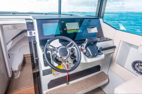 Slide: The Image of 2024 Saxdor 320 GTC helm station with advanced navigation system and ocean view. - 12
