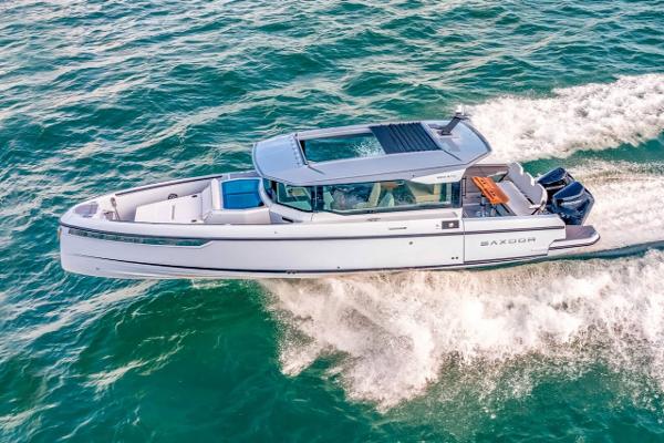 Slide: The Image of 2024 Saxdor 320 GTC boat cruising on open water. - 16