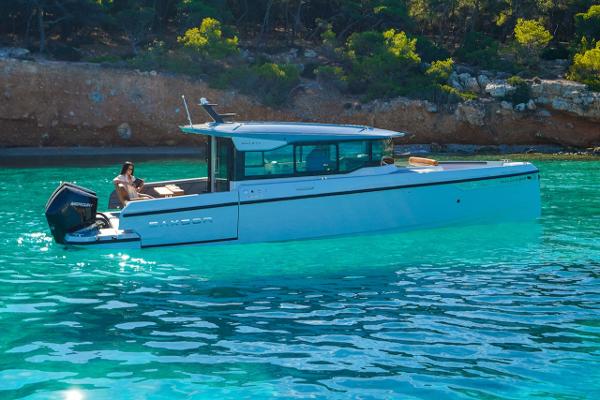 Slide: The Image of 2024 Saxdor 320 GTC boat cruising in clear turquoise waters. - 2