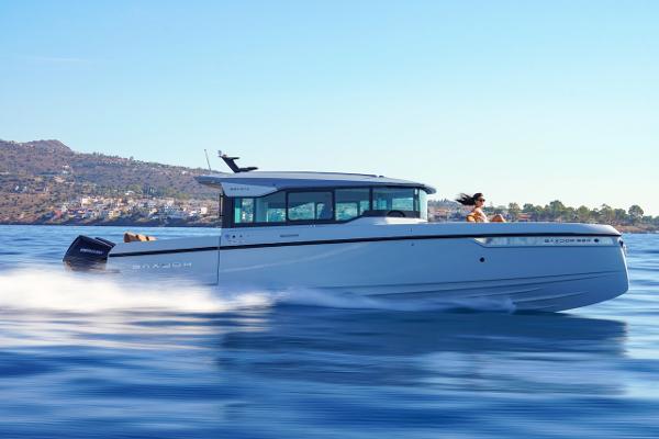 Slide: The Image of 2024 Saxdor 320 GTC cruising on a sunny day near the coastline. - 7